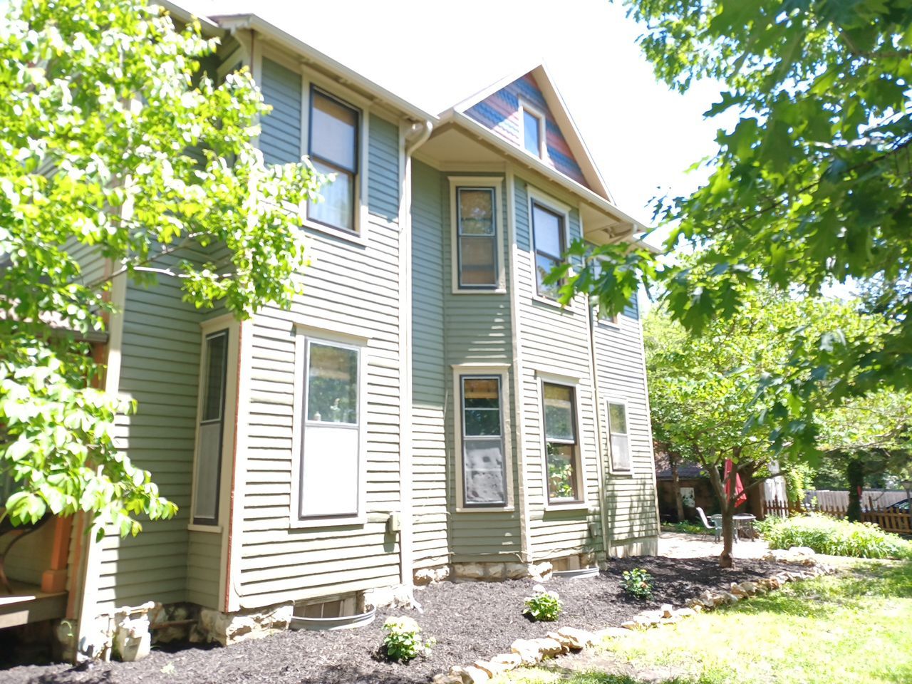 Light green siding house exterior painting in Lawrence, KS