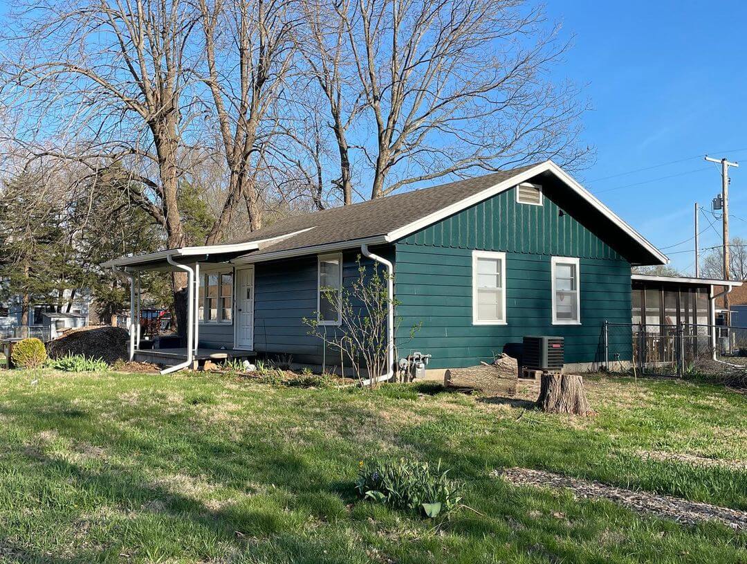 Green house exterior in Lawrence, KS, showcasing updated paint.