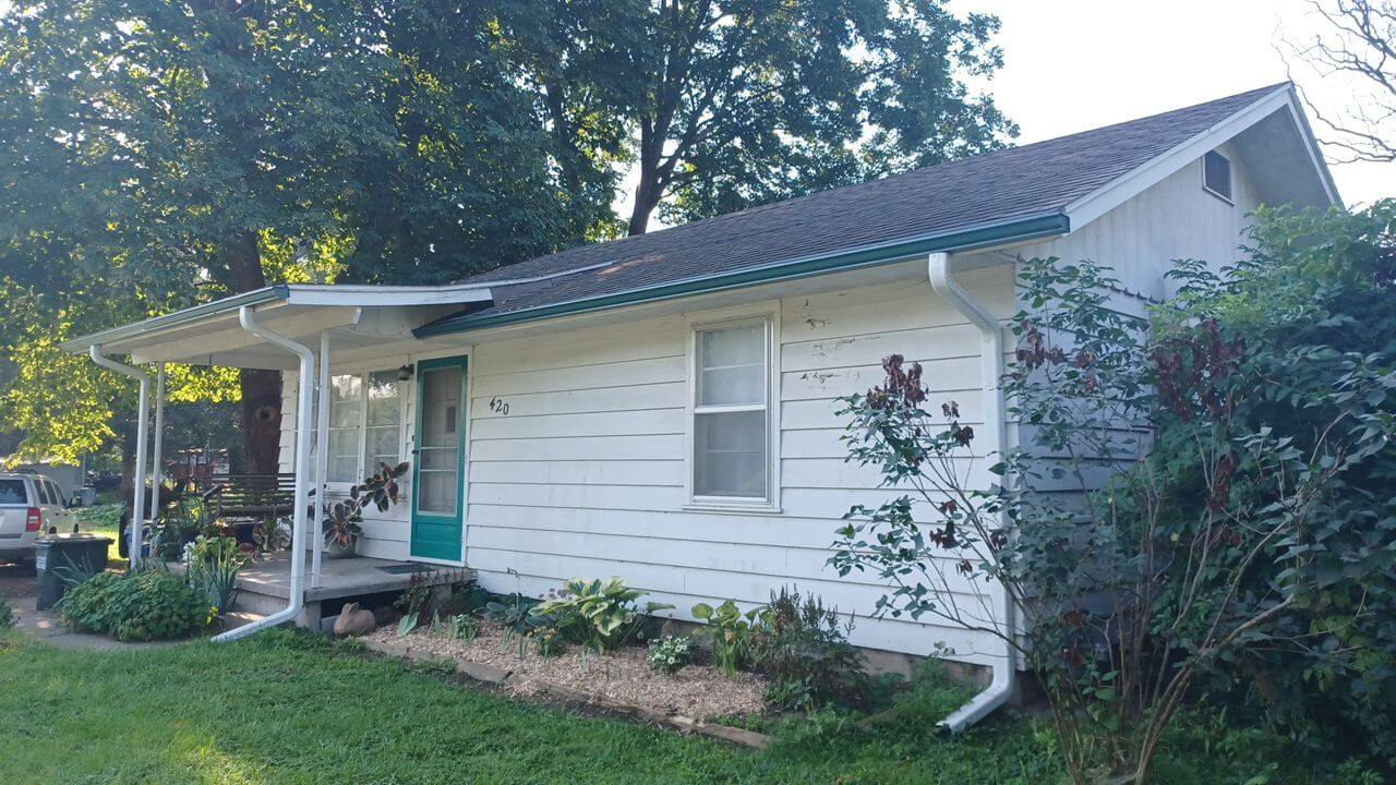White house exterior with teal door, Lawrence KS