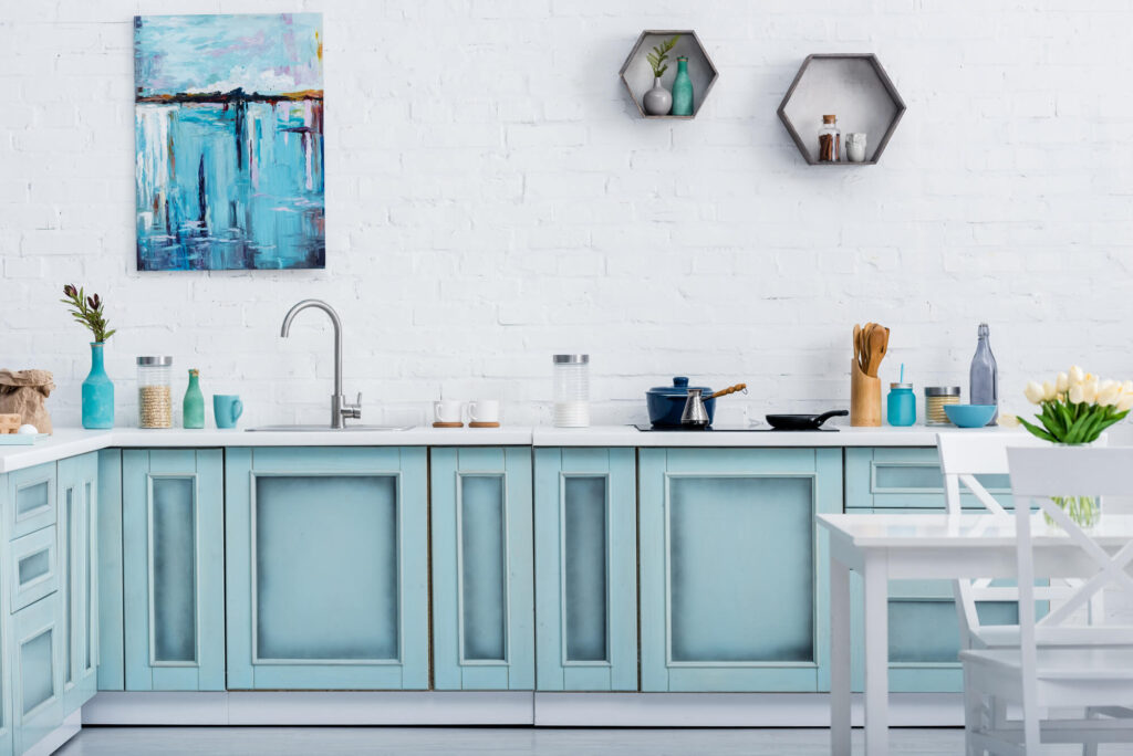 Sink area with sky blue painted cabinets- cabinet painters in Lawrence, KShow to sand cabinet doors for painting
