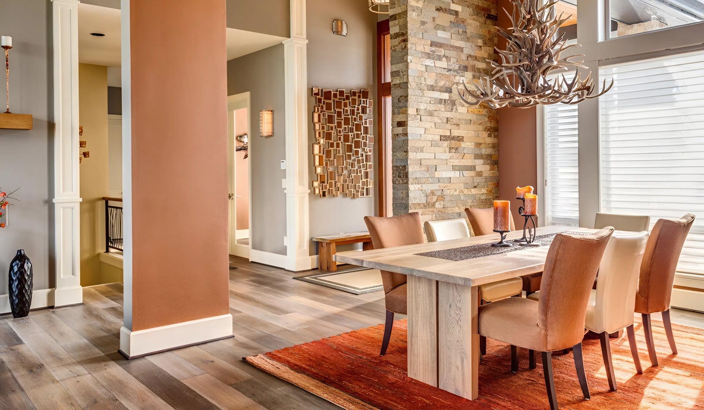 Dining room with warm earth-tone walls and soft gray accents by an interior painter in De Soto, KS.