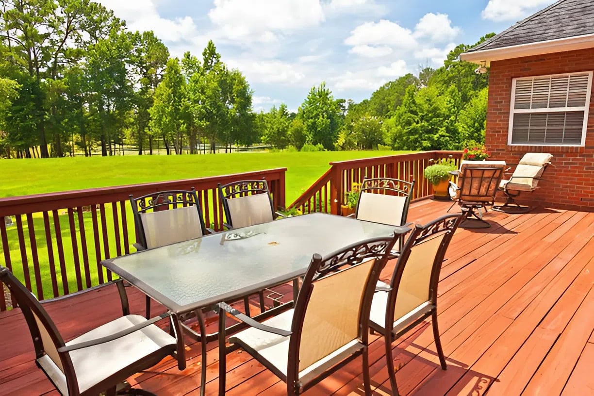 Stained backyard deck and railing restored by a professional painter in Fairway, KS