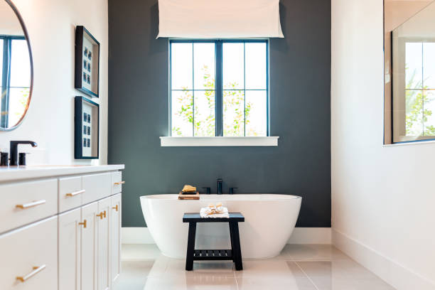 Bathroom with a dark charcoal accent wall and white trims by an interior painter in De Soto, KS.