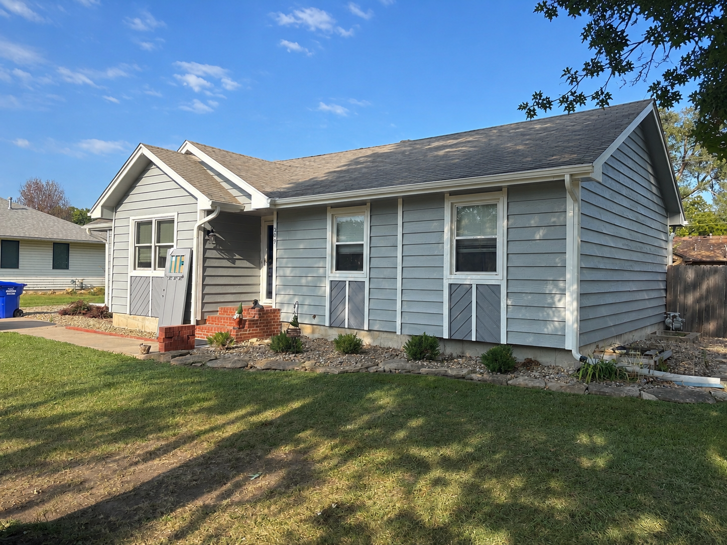 Topeka home exterior painting: gray siding with white trim and accents.